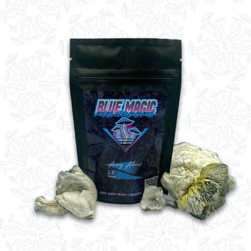 A sealed package of magic mushrooms behind a small pile of dried magic mushrooms