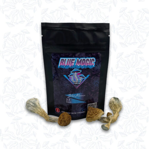 A sealed package of magic mushrooms behind a small pile of dried thin magic mushrooms