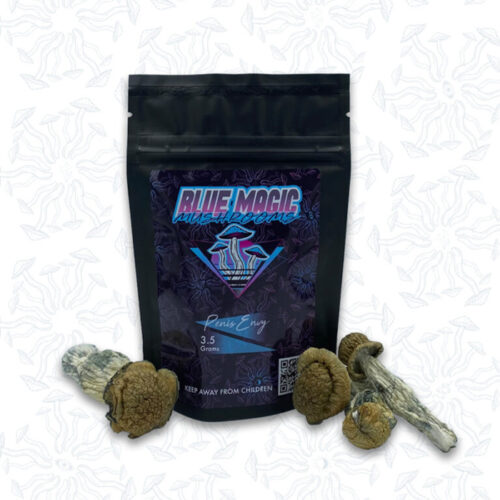 A sealed package of magic mushrooms behind a small pile of dried thin magic mushrooms